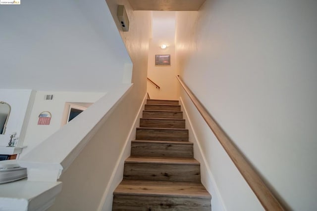 stairway with hardwood / wood-style flooring