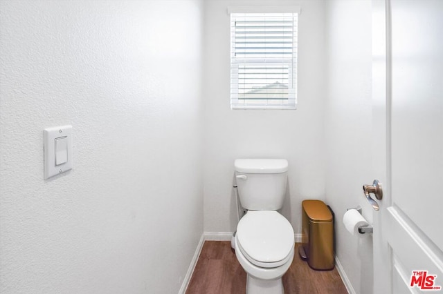 bathroom with toilet and wood-type flooring