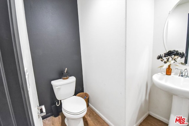 bathroom with sink, hardwood / wood-style floors, and toilet