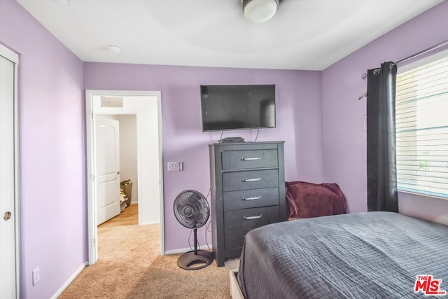 bedroom featuring light carpet