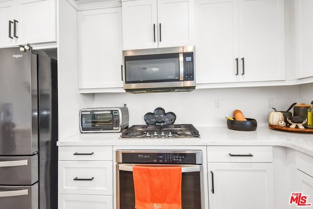 kitchen with stainless steel appliances and white cabinetry