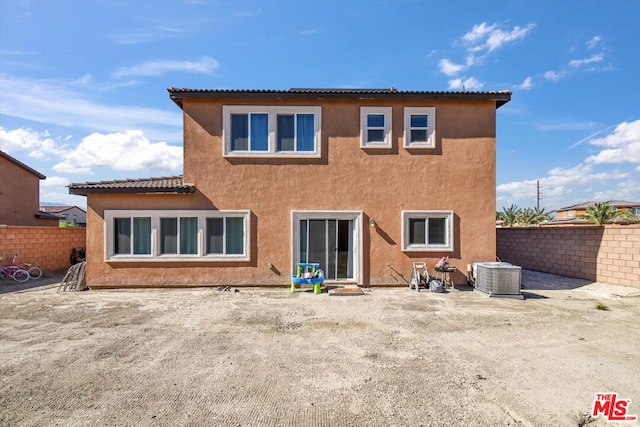 rear view of property featuring central AC