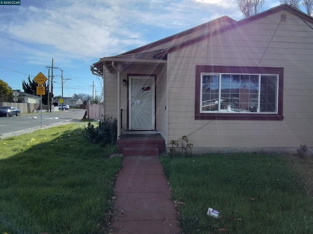 entrance to property featuring a yard