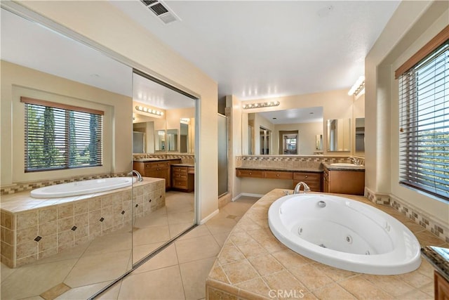 bathroom featuring a whirlpool tub, tile patterned flooring, and vanity