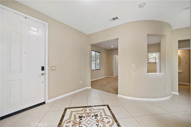 entryway with visible vents, baseboards, and light tile patterned floors