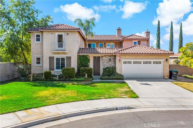 mediterranean / spanish-style home featuring an attached garage, driveway, a front yard, and stucco siding