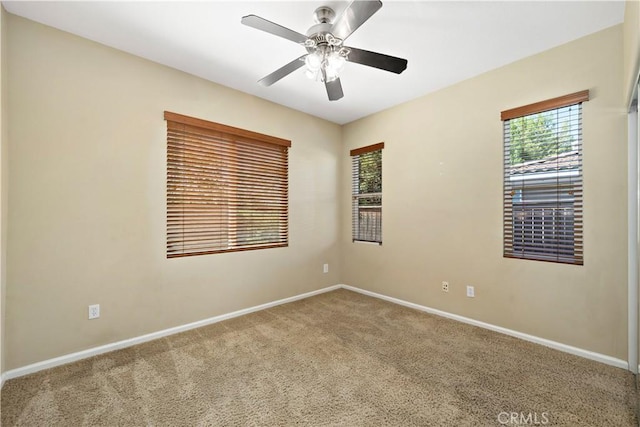 carpeted empty room with baseboards and a healthy amount of sunlight