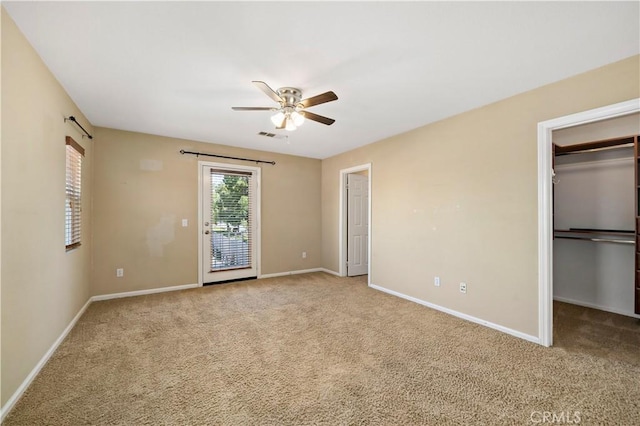 unfurnished bedroom featuring light carpet, baseboards, and access to exterior