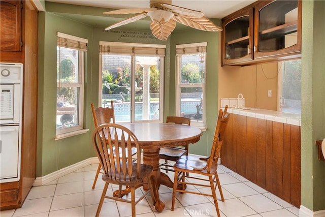 tiled dining room with ceiling fan