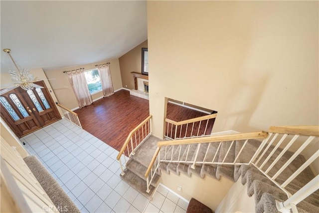 interior space featuring lofted ceiling and tile patterned flooring