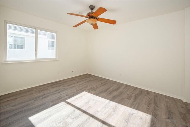 spare room featuring ceiling fan and dark hardwood / wood-style flooring