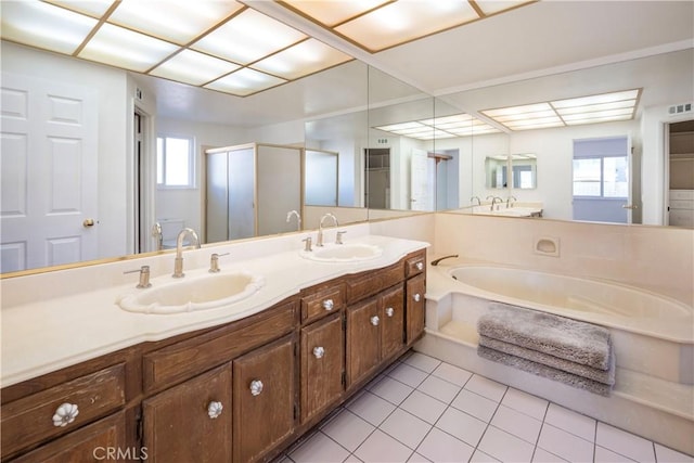 bathroom featuring a healthy amount of sunlight, tile patterned floors, separate shower and tub, and vanity