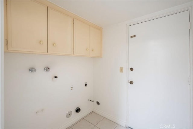 clothes washing area with cabinets, light tile patterned floors, gas dryer hookup, and electric dryer hookup