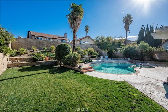 view of swimming pool featuring a lawn and a patio