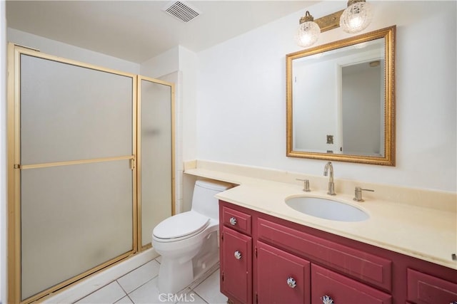 bathroom featuring toilet, vanity, tile patterned flooring, and an enclosed shower