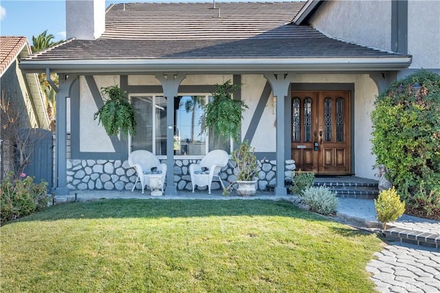 entrance to property featuring a lawn