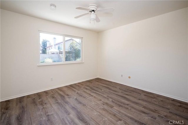 spare room with ceiling fan and dark hardwood / wood-style floors