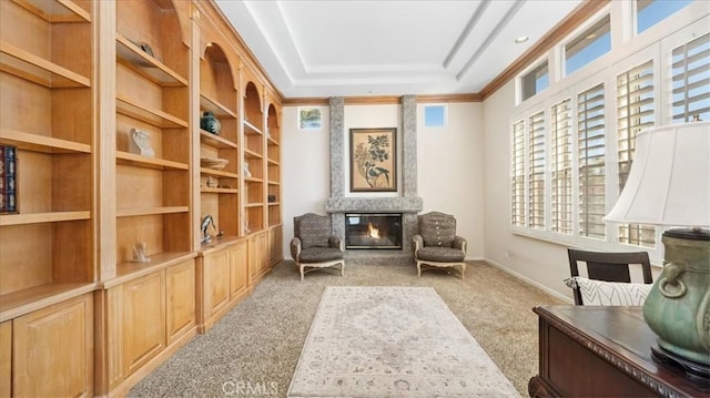 sitting room featuring a multi sided fireplace, ornamental molding, and light carpet