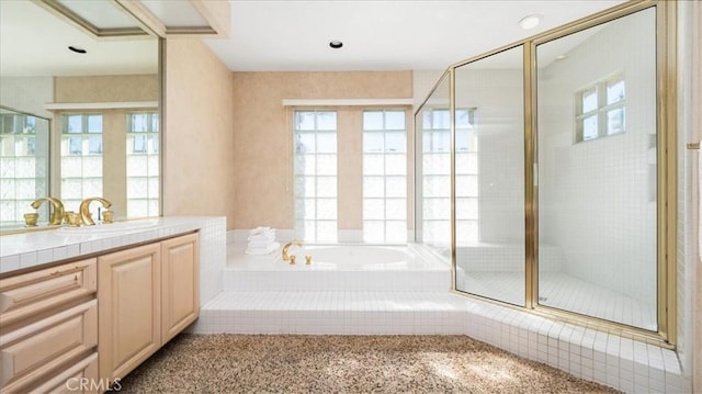 bathroom with plenty of natural light, vanity, and independent shower and bath