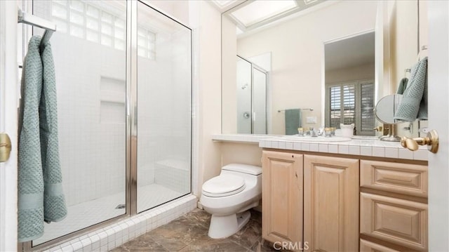 bathroom with vanity, toilet, and walk in shower