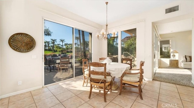 dining room featuring light tile patterned floors and an inviting chandelier