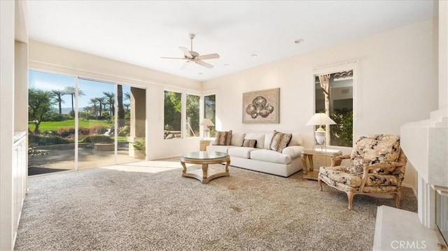 living room with ceiling fan and carpet