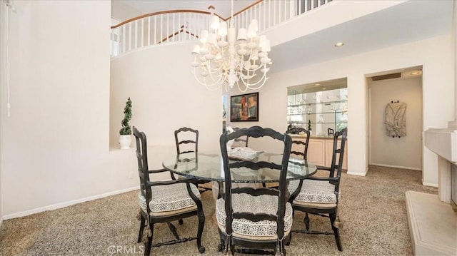 dining area with a notable chandelier, light colored carpet, and a high ceiling