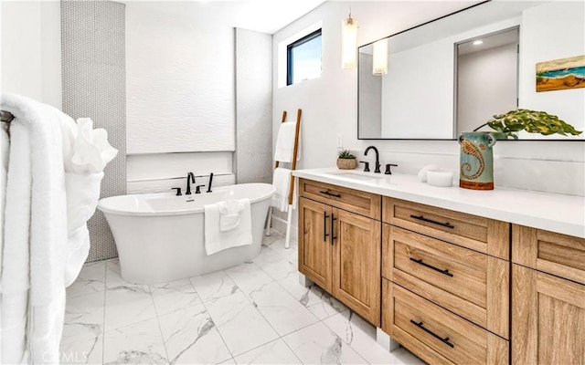 bathroom featuring a tub to relax in and vanity