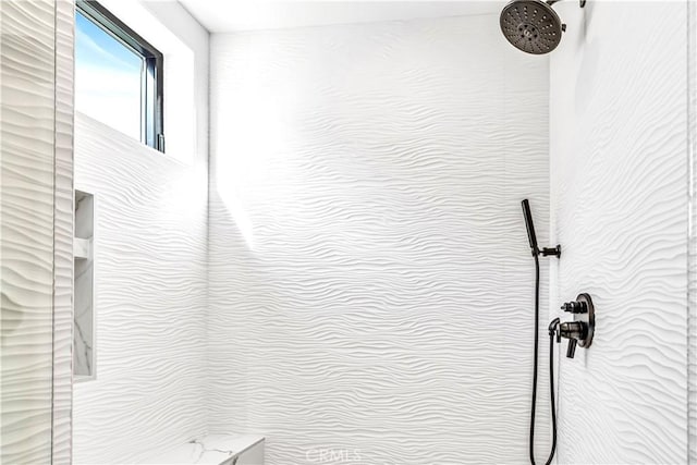 interior details featuring tiled shower