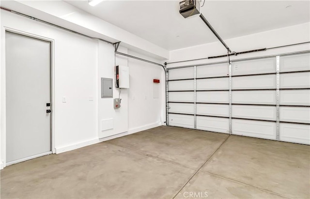 garage with a garage door opener and electric panel