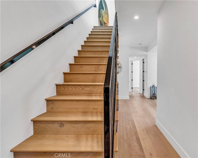 stairs featuring hardwood / wood-style flooring