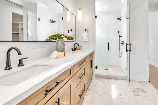 bathroom with a shower with shower door and vanity