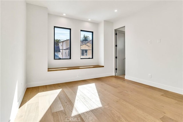 spare room featuring light hardwood / wood-style floors