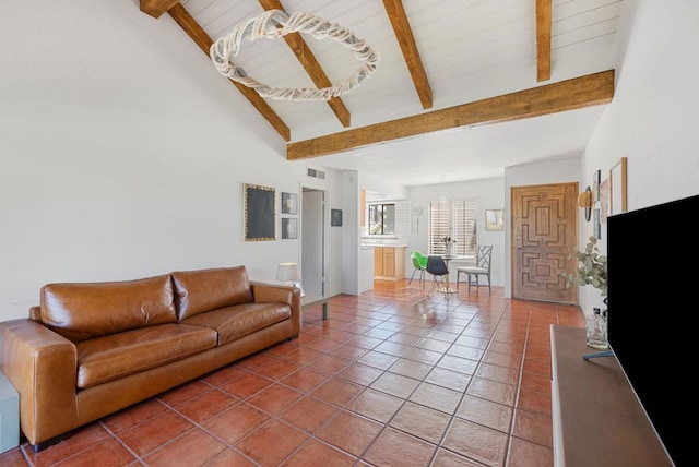 tiled living room featuring beam ceiling and high vaulted ceiling