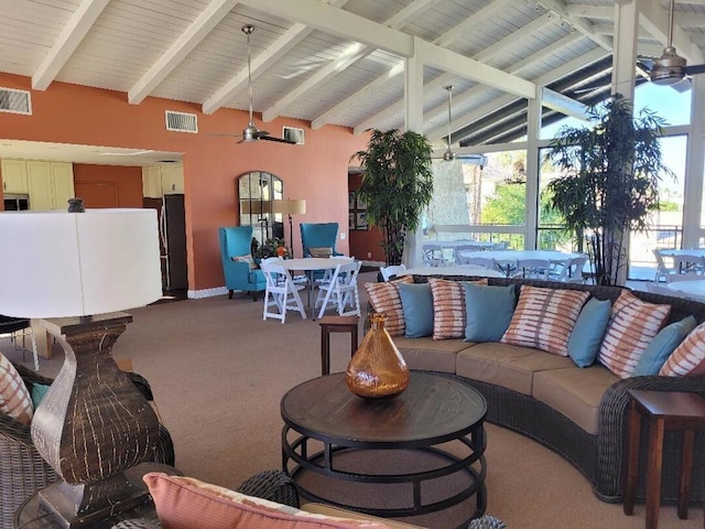 interior space with carpet flooring, vaulted ceiling with beams, ceiling fan, and a wealth of natural light