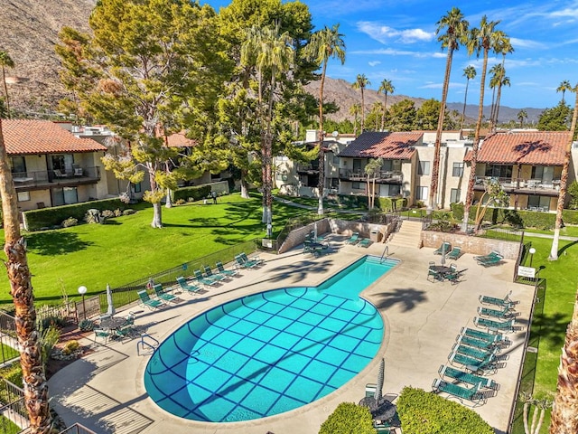 view of pool with a mountain view and a patio