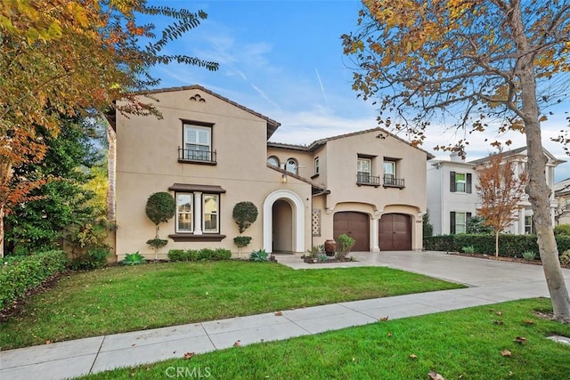 mediterranean / spanish-style house with a front lawn and a garage