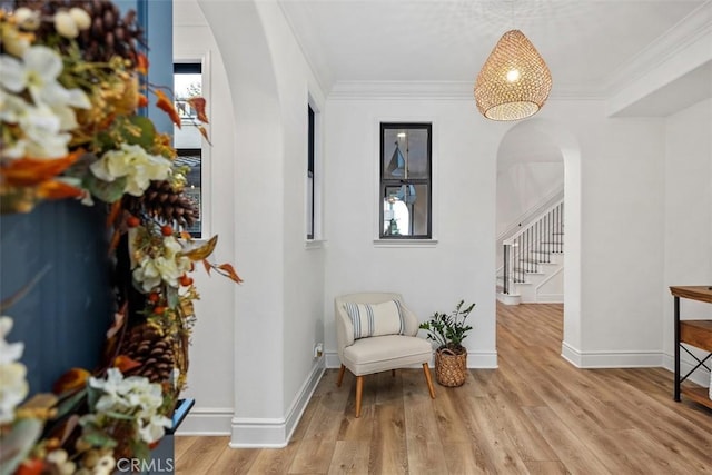 sitting room featuring light wood-type flooring and ornamental molding