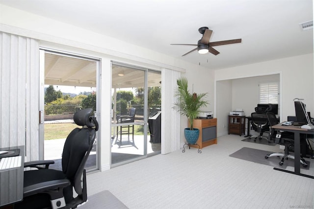 carpeted home office with ceiling fan