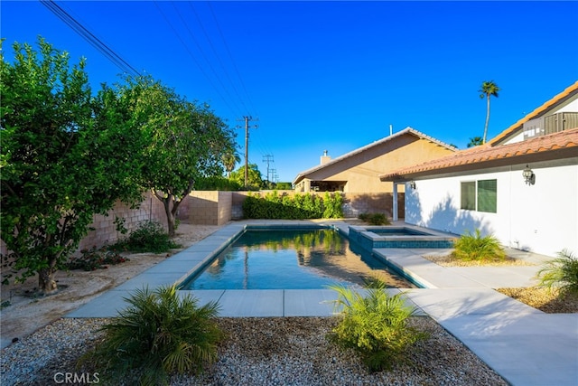 view of pool featuring an in ground hot tub