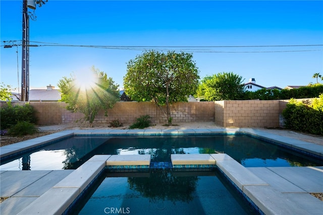 view of swimming pool featuring an in ground hot tub