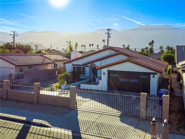 view of front facade with a mountain view and a garage