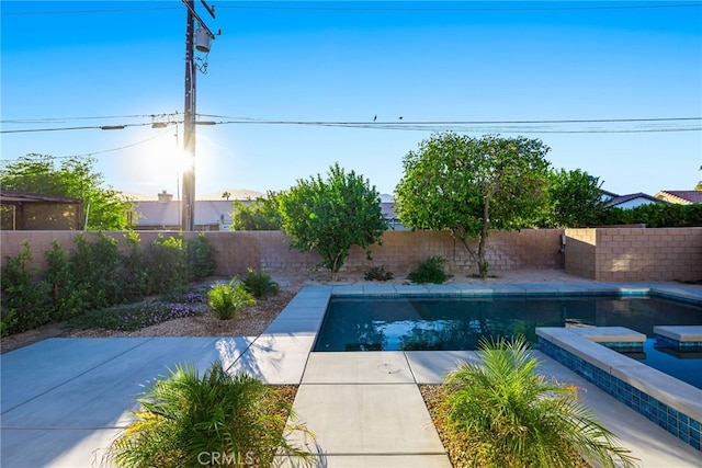 view of pool with a hot tub