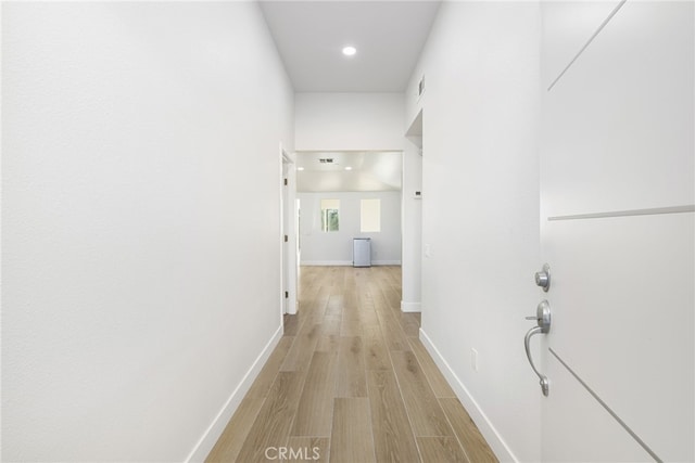 hallway with light hardwood / wood-style flooring