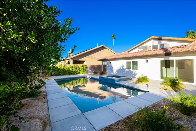 view of swimming pool with an in ground hot tub