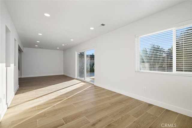 spare room featuring light hardwood / wood-style floors