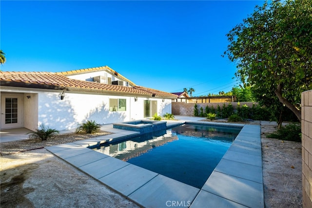 view of swimming pool with an in ground hot tub