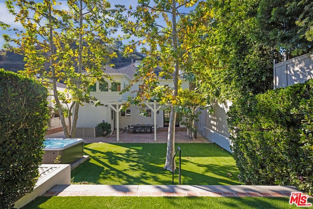 view of yard with a patio area and a hot tub