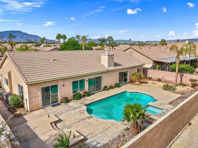 view of swimming pool featuring a mountain view and a patio