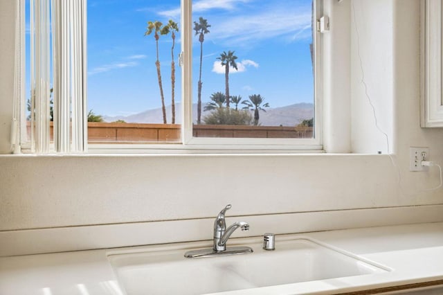 bathroom with a mountain view, sink, and a wealth of natural light